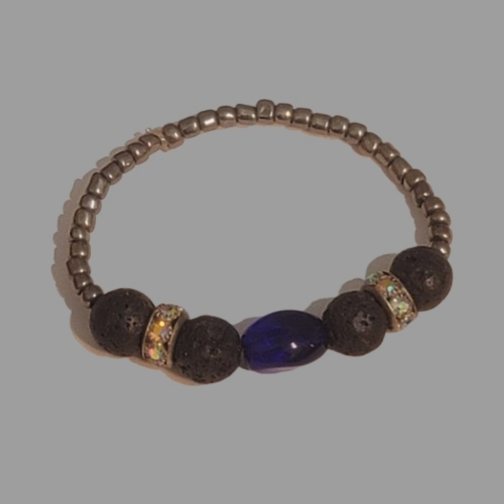 Lava bead bracelet with a large blue stone and embellished spacer bead